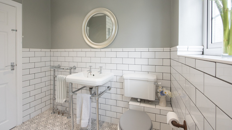 white and grey outdated bathroom