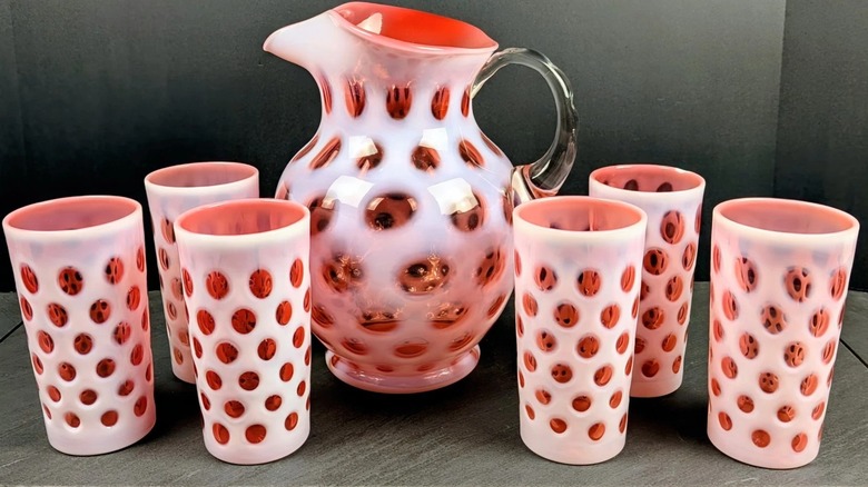A Fenton Art Glass Opalescent cranberry Coin Dot pitcher with tumblers
