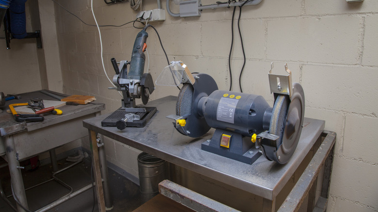 A bench grinder and an angle grinder mounted in a cutoff jig