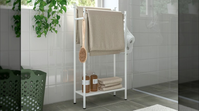 ENUDDEN Towel stand with towels and bathroom supplies on rails and shelves
