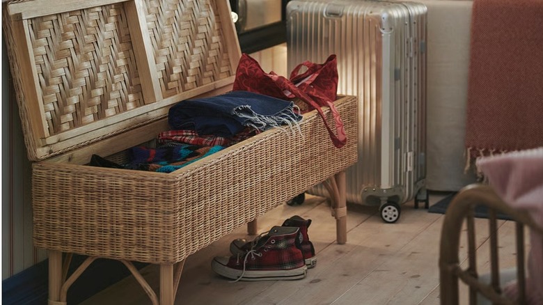TOLKNING Bench with storage with clothes in storage section
