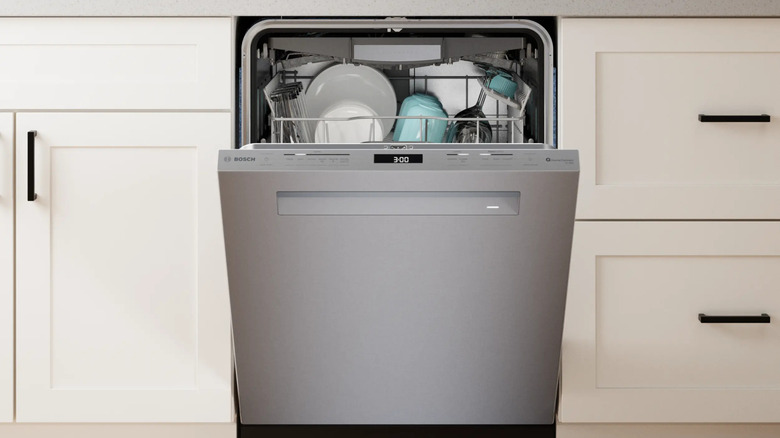An open Bosch dishwasher full of dishes