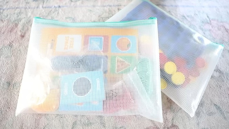 Jot zipper bags with game pieces stored inside