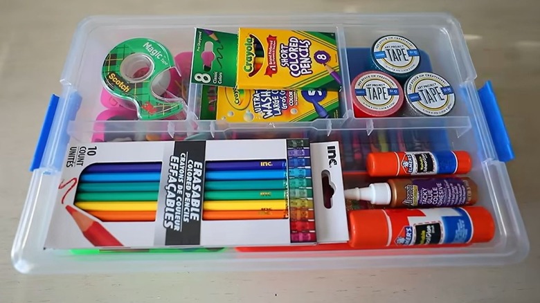 Stackable slotted storage case filled with random school supplies