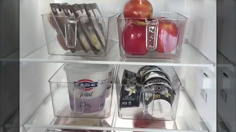 Clean plastic bins with handles loaded with refrigerated items