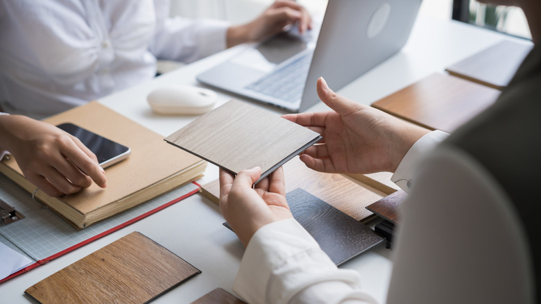 Designers comparing different flooring options