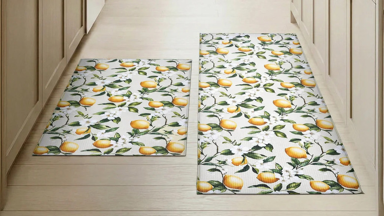 Two lemon-print rugs lay next to each other on a beige kitchen floor