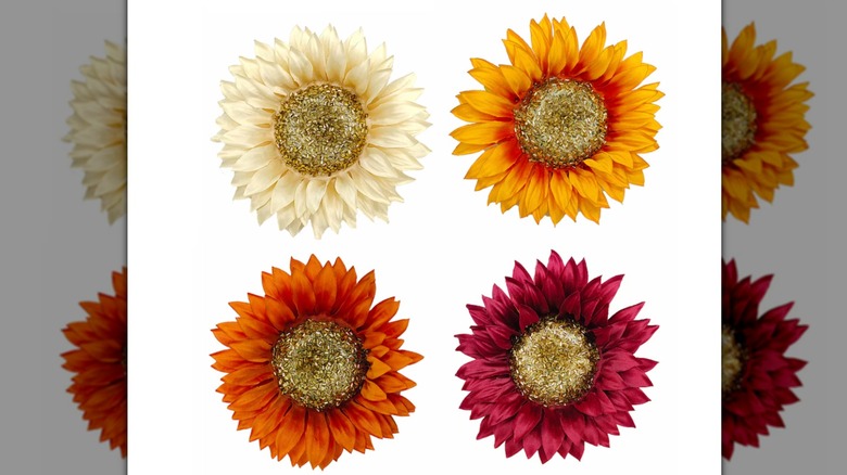 Four warm-toned faux sunflowers with gold centers