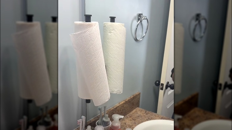 Paper towel stuck on mirror rod in bathroom