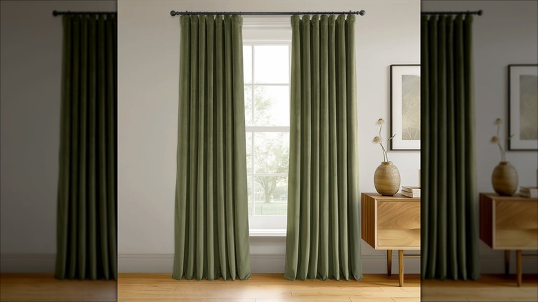 Gracie Oaks Olivia blackout curtains in hunter green hanging in a window
