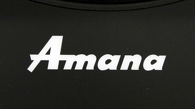 An Amana logo on a black appliance
