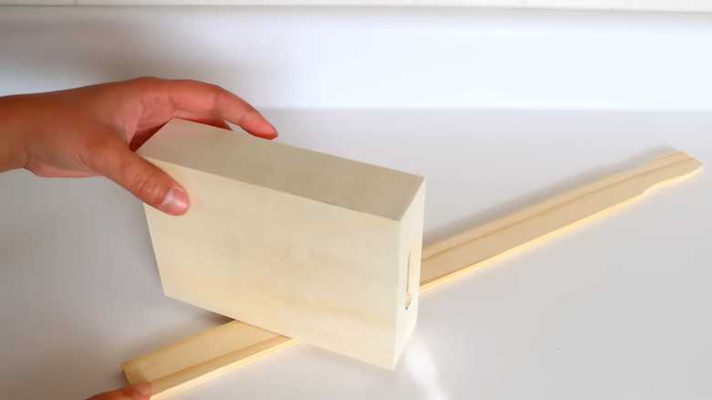 Creator preparing the materials to create a Dollar Tree shelf