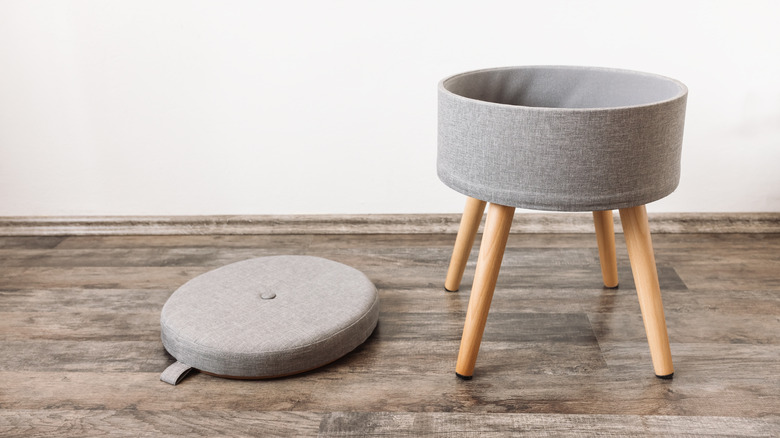 A small storage ottoman with the lid removed