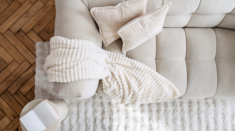 Cozy blanket draped over couch