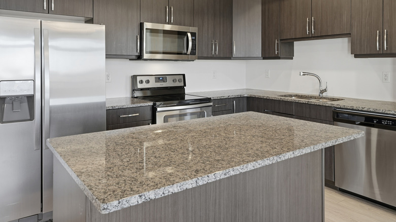 A gray granite countertop in a kitchen