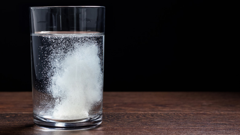 Alka-Seltzer fizzing in glass of water