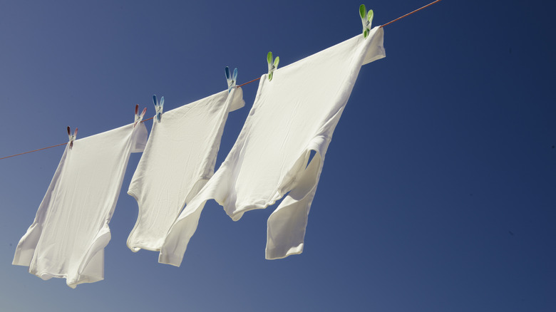 Bright white shirts hanging on line