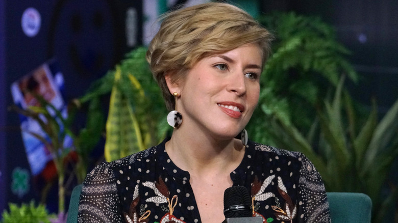 Erin Napier holding the microphone and smiling thoughtfully