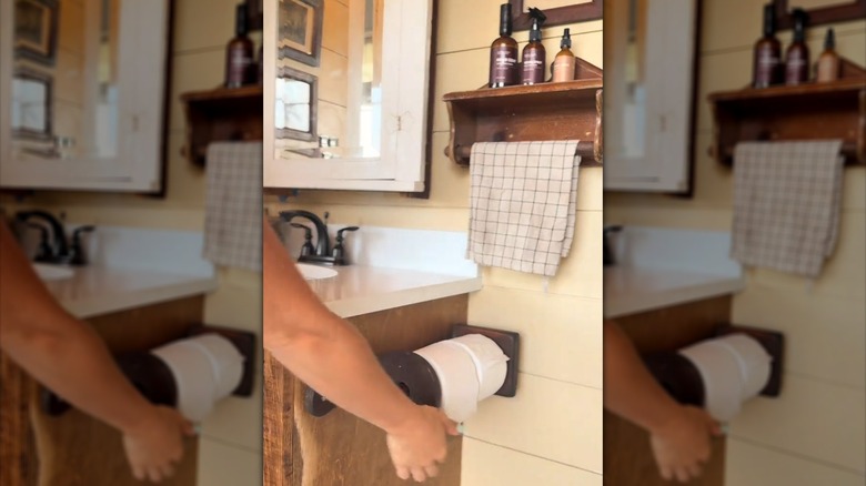 Two vintage wooden paper towel holders used in a bathroom