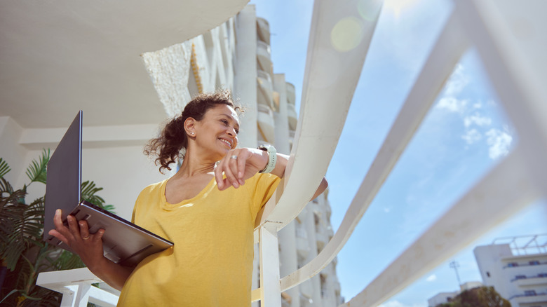 Woman standing on a balcony with open railings