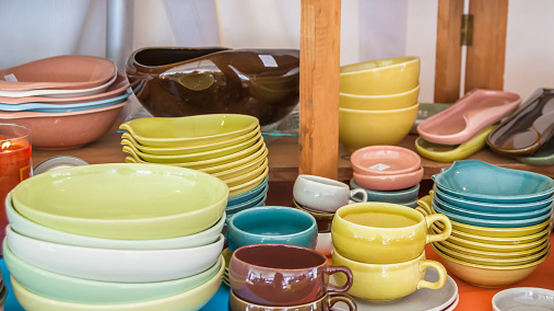 A collection of colorful pottery on a shelf