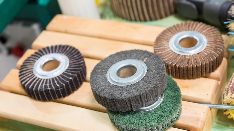 Collection of flap wheels and discs for a bench grinder.