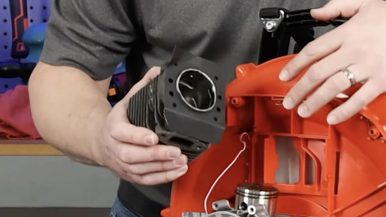 Man examining engine of his leaf blower