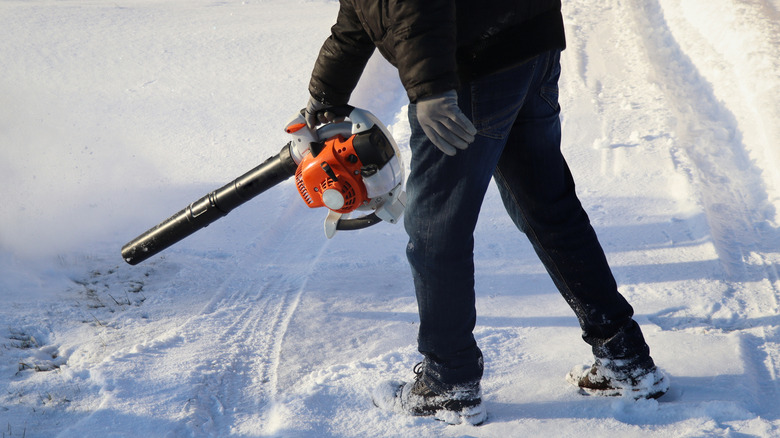 Man using snowblower to remove snow