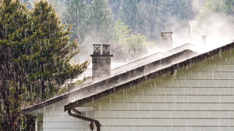 Spring rain shower over residential neighborhood roofs