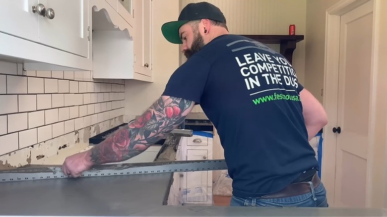 Contractor leveling poured concrete countertops.