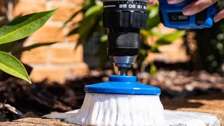 A rotary scrub brush attached to a drill