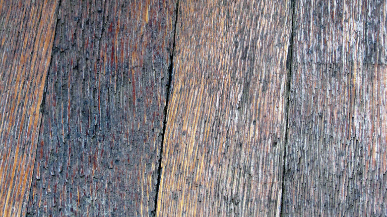 old, uneven, textured wood flooring close up