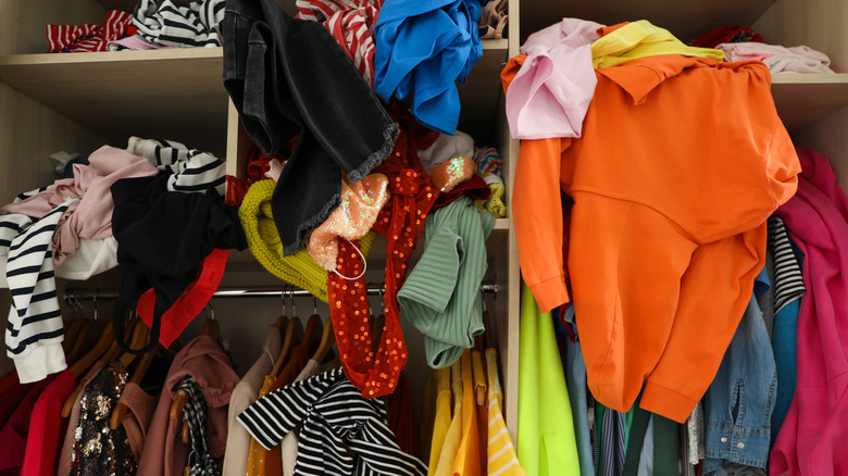 messy closet with too many clothes piled in