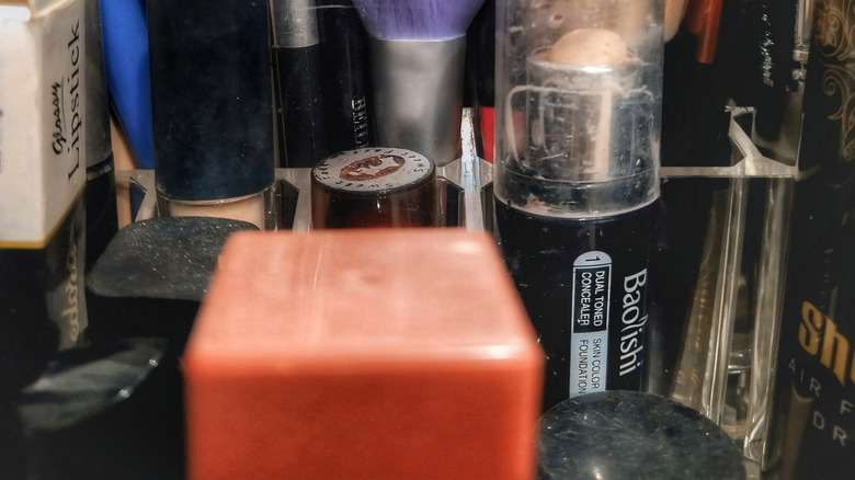 close up image of makeup and makeup brushes