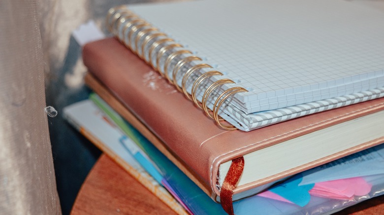 stack of journals and notebooks on top of a table