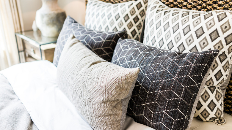 stack of pillows on a bed