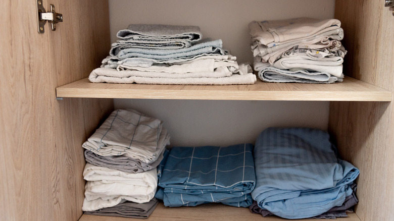 linen closet with organized and limited number of sheets and towels