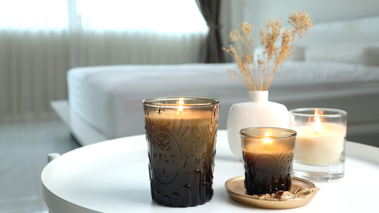 close up image of candles in a white bedroom