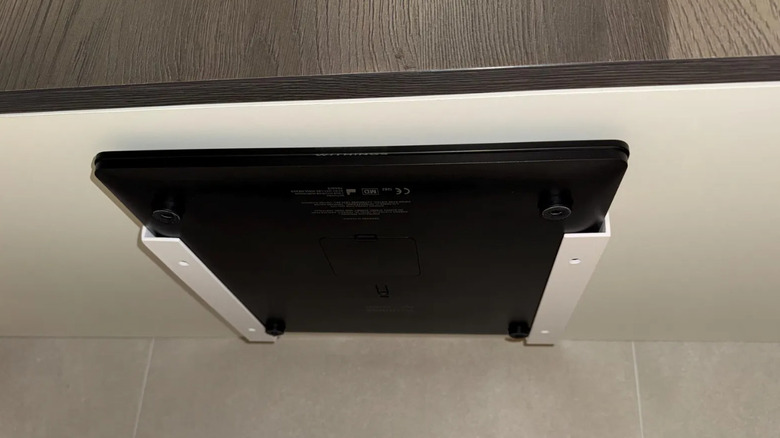 A bathroom scale storage system in use