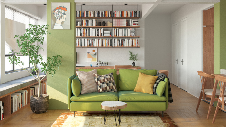 Library with hanging bookshelves and a green loveseat