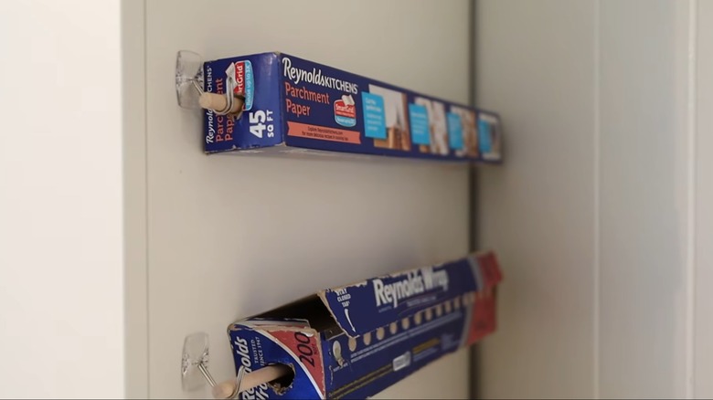 Parchment paper and aluminum foil containers mounted on cabinet side