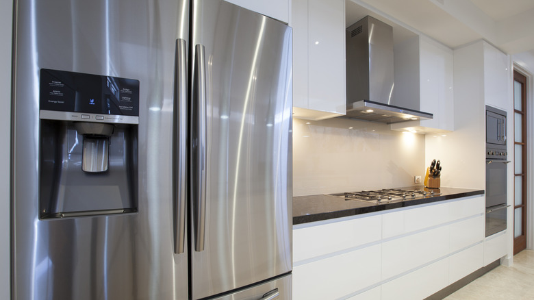 A sleek stainless steel fridge in a white kitchen