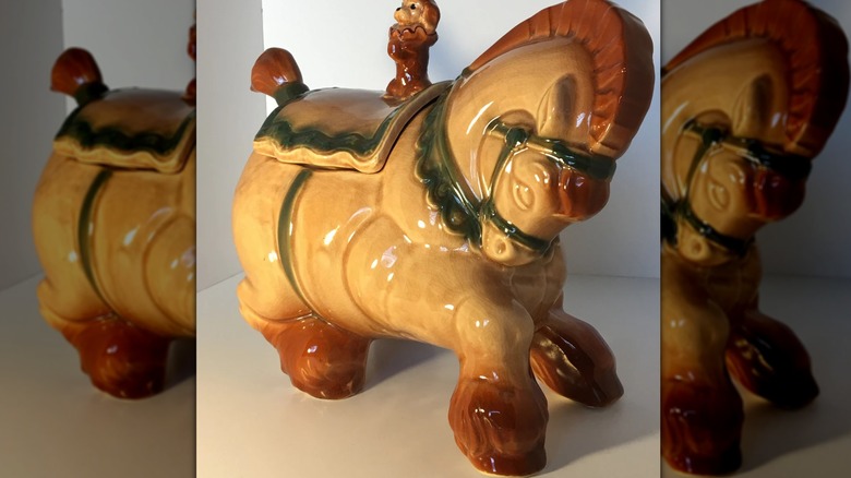 Vintage Brush Pottery Co. circus horse cookie jar in tan, brown, and green color scheme on white countertop