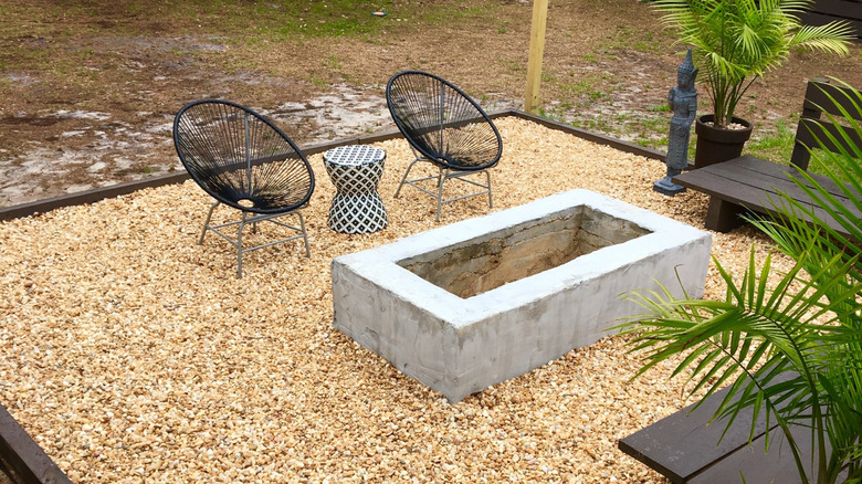Light pea gravel patio with chairs and fire pit