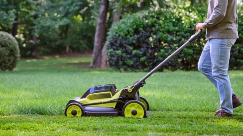 Man pushing Ryobi RY401170VNM mower