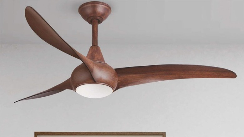 A natural wood Minka-Aire Light Wave ceiling fan in a modern living room