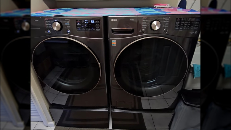 An LG ThinQ Washer WM4000HBA and Dryer DLEX4000B side-by-side in a home with a towel on top of them