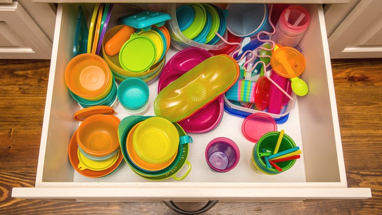 Food storage container lids piled into cabinet