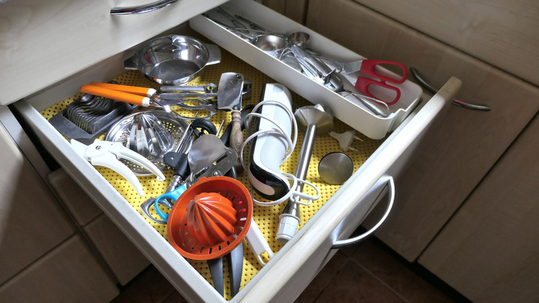 A messy kitchen drawer