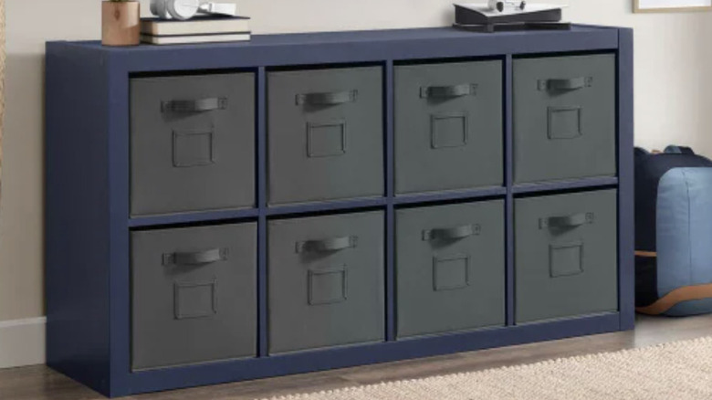 blue storage unit placed horizontally with eight removable grey fabric boxes